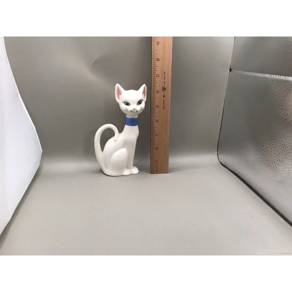 Pretty White Porcelain‎ Kitty With Green Eyes And A Blue Collar